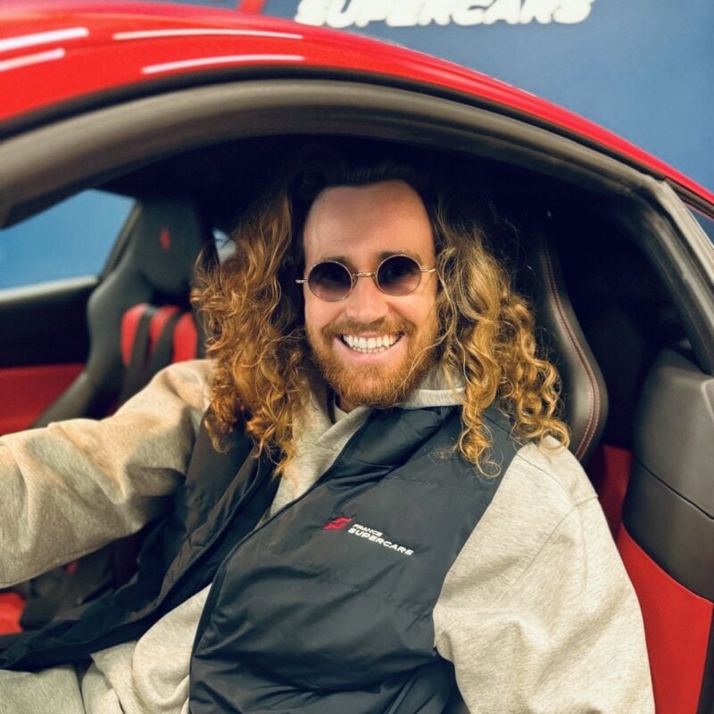 Maxime Langlais sitting in the driver's seat of a car